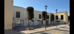 a large white building with trees in a courtyard at Dimora L&A in Portocannone