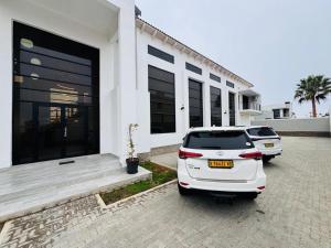 a white car parked in front of a house at Carlo's Fairview Boutique - Hotel in Walvis Bay