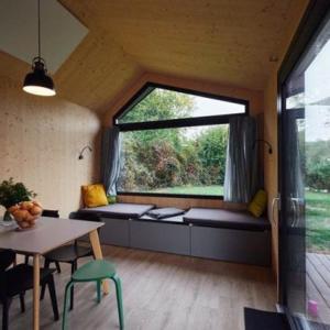 a room with a large window with a table and chairs at Wellnester Tiny Houses in Losheim am See in Losheim +17 photos