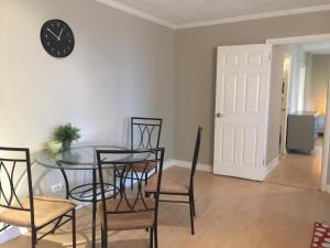 a dining room with a table and chairs and a clock at Downtown Big 1 Bedroom #20I in Atlanta