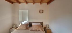 a bedroom with a bed with two pillows on it at Casa do Salgueirinho in Casal do Rei +50 photos