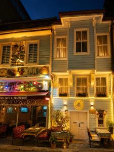 a building with a restaurant in front of it at night at Hill House butik in Istanbul +19 photos