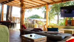 a screened in porch with couches and a tv at Campo Di Mare in Porto-Vecchio