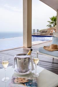 a table with a bottle of champagne and two glasses at Hotel Metropole Taormina in Taormina
