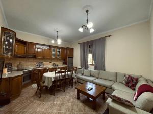 a living room with a couch and a table at 3 Roots Villa in Krujë