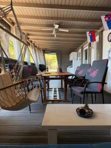 a room with a hammock and a table and chairs at MOBILE HOME Nikol in Pirovac