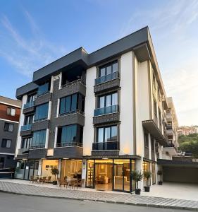 an apartment building with a black roof at Osmanlı Suite Airport TRABZON in Trabzon