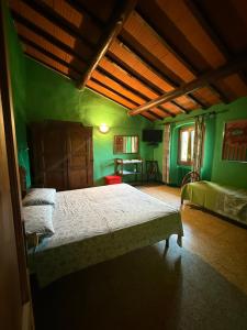 a bedroom with a bed in a green room at Tenuta Selvaggia in Reggello +82 photos