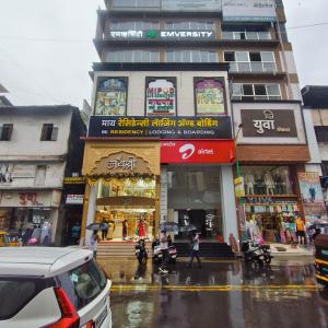 a building on a city street in the rain at Mi Residency Lodging & Boarding in Thane
