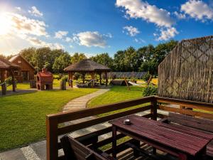 a wooden bench on a fence with a playground at Domki Nad Morzem Sobiescy in Stegna