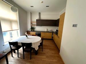 a kitchen with a table and chairs in a room at Cathedral Apartment Tartu in Tartu
