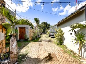 a cobblestone street in front of a house with christmas lights at Villa Araya in Nusa Dua