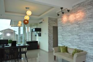 a living room with a couch and a brick wall at The Baiti in Bandar  Pusat Jengka