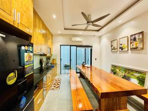 a kitchen with a wooden counter top in a room at Bay Homestay in Cam Lâm