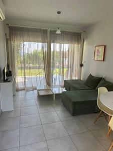 a living room with a couch and a table at Glikis ear apartments in Gliki