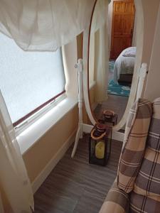 a bedroom with a bed and a window at Owls Roost in Stowmarket