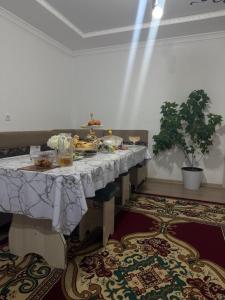 a table with food on it in a room at Beshik Guest House in Bokonbayevo +5 photos