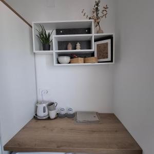 a room with white shelves and a wooden floor at Room Mate in Malinska