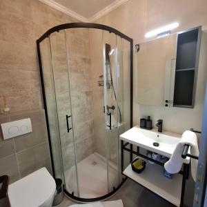 a bathroom with a shower and a sink at Room Mate in Malinska +8 photos