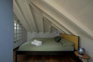 a bed in a room with an attic at Alassio Black Loft in Alassio