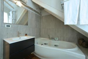 a bathroom with a sink and a bath tub at Alassio Black Loft in Alassio +25 photos