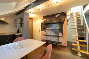 a kitchen and dining room with a table and chairs at Alassio Black Loft in Alassio