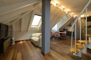 a living room with a couch and a table at Alassio Black Loft in Alassio