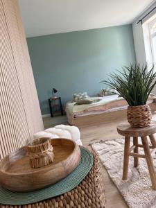 a living room with a table and a couch at Balcony by Giorgi - Centre de Bastogne in Bastogne +6 photos