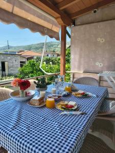 a blue and white checkered table with food on it at Lana's House in Berat