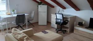 a living room with a couch and a desk with a computer at Moon Light-free parking in Rijeka