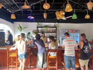 a group of people standing at a bar at Sunrise Bungalows in Kaôh Rŭng (3) +7 photos