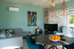 a living room with a table with oranges on it at Boutique Guesthouse-Moncarapacho in Moncarapacho