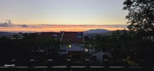 a house with the sunset in the background at פינה שלווה בטבע- A peaceful spot in nature in Bet HaShitta +26 photos