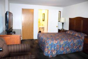a hotel room with a bed and a television at Stevenson Motel Federal Way near I 5 in Federal Way