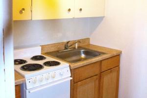 a kitchen with a sink and a stove at Stevenson Motel Federal Way near I 5 in Federal Way
