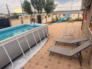 a swimming pool with a swing and a playground at Nistor House-Delta Retreat in Tulcea