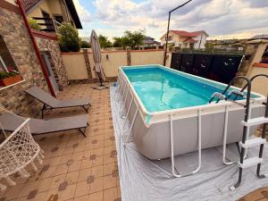 a large hot tub on a patio next to a house at Nistor House-Delta Retreat in Tulcea
