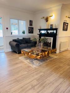 a living room with a couch and a coffee table at Daviot Lodge in Inverness