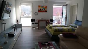 a living room with a couch and a table at Gästehaus Ingrid in Ramsthal