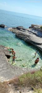 a group of people swimming in a body of water at Oasi della Divina Volontà in San Giovanni Rotondo