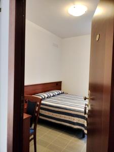 a bedroom with a bed and a chair in it at Oasi della Divina Volontà in San Giovanni Rotondo +22 photos