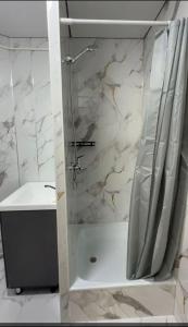 a bathroom with a shower and a sink at Janai in Karakol