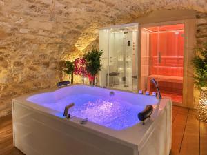 a large bathroom with a large blue tub at Château De La Caze Piscine & Spa - Ste Enimie in Sainte-Énimie