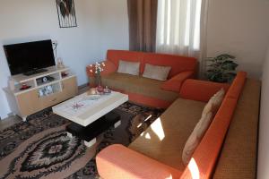 a living room with a couch and a table at Swimming Pool - Leko House Perondi in Kuçovë