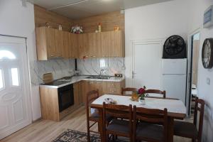 a kitchen with a table and chairs and a kitchen with a stove at Swimming Pool - Leko House Perondi in Kuçovë +24 photos