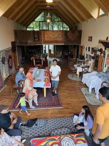 a group of people sitting in a living room at Moksha Resort Hunza in Chamangul