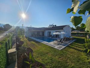 a house with a swimming pool in a yard at Private Pool Villa with Jacuzzi & Garden in Girdev