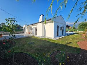 a small white church with a grass yard at Private Pool Villa with Jacuzzi & Garden in Girdev