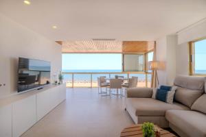 a living room with a couch and a view of the ocean at Ag Bermudas Premium in Gandía