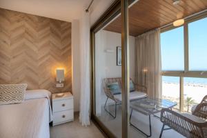 a bedroom with a bed and a table and a chair at Ag Bermudas Premium in Gandía +105 photos